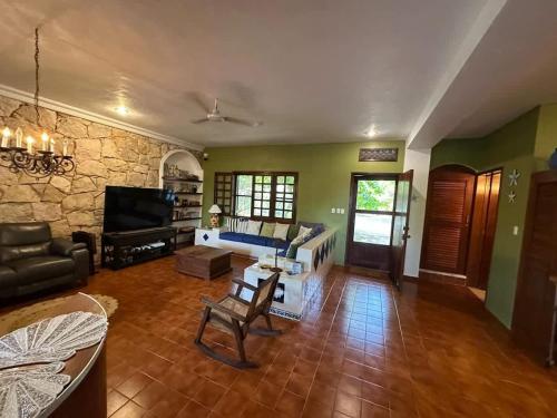 a large living room with a couch and a television at Los Dias Enmedio in Telchac Puerto