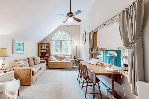 a living room with a couch and a table with a desk at Secluded Sanctuary in West Wardsboro