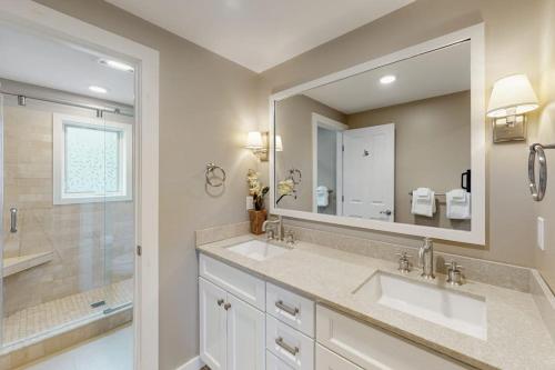 a bathroom with two sinks and a large mirror at 366 Ghia Farm Road in Ludlow