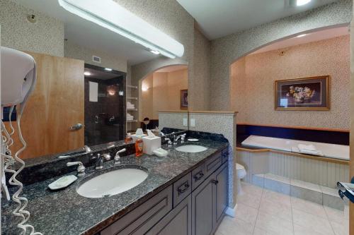a bathroom with two sinks and a large mirror at Owls Unit #6 in Jeffersonville