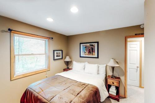 a bedroom with a large bed and a window at Wardsboro Family Escape in Wardsboro