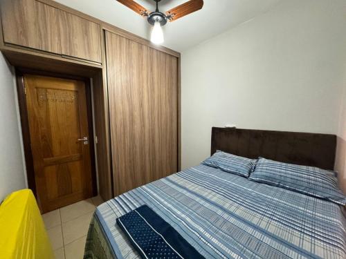 a bedroom with a bed with a laptop on it at Sobrado Azul in Várzea Grande