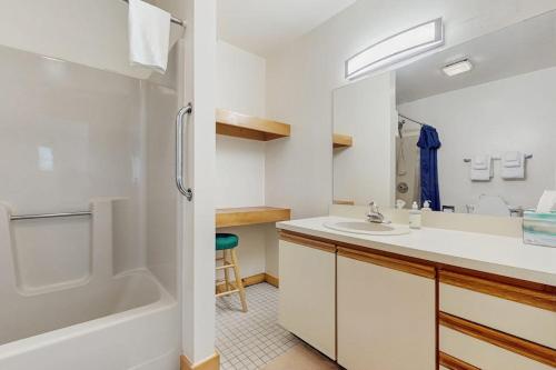 a bathroom with a tub and a sink and a shower at Haystack 32 in Wilmington