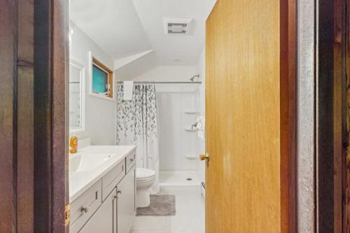 a bathroom with a white sink and a toilet at Stowebury Retreat in Waterbury Center