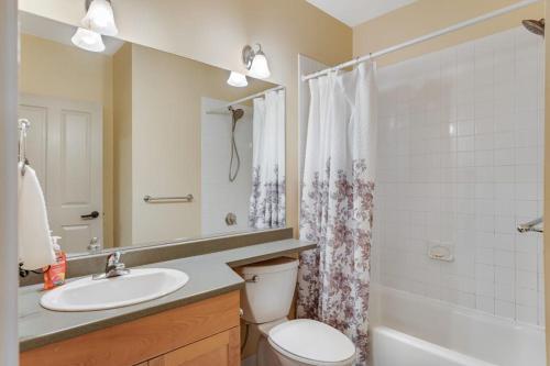 a bathroom with a toilet and a sink and a shower at Long Trail House 368 in Stratton