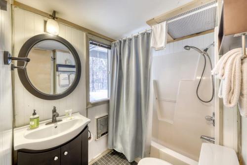 a bathroom with a sink and a toilet and a mirror at Mount Snow Chalet in West Dover