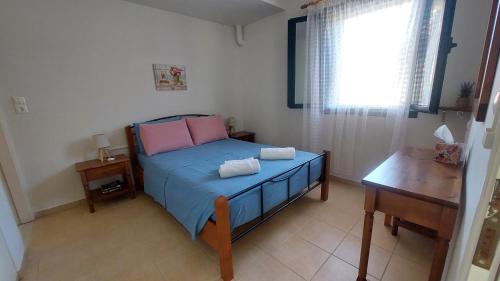 a bedroom with a bed with two towels on it at Giannos Apartments in Agia Effimia