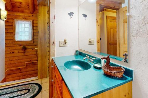 a bathroom with a blue sink in a cabin at 262 Ghia Farm Road in Ludlow