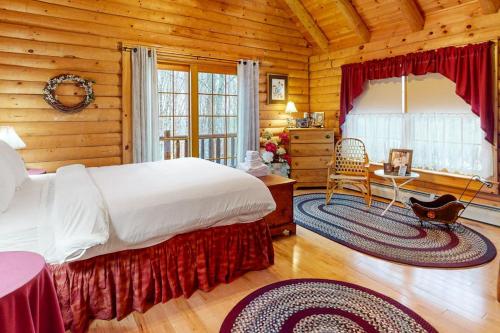a bedroom with a large bed in a log cabin at 262 Ghia Farm Road in Ludlow