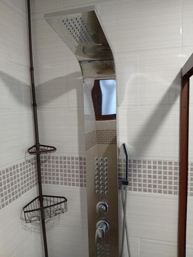 a shower in a bathroom with a glass door at Cómodo departamento en Xochimilco in Mexico City