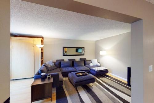 a living room with a blue couch and a table at Gore Creek Getaway in Vail