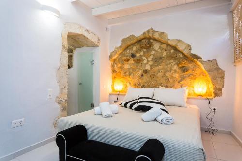a bedroom with a bed with a large headboard at Mediterraneo Suite Home in Rethymno