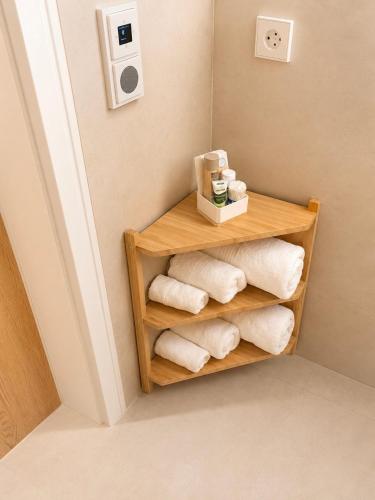 a bathroom with towels on a shelf in a room at Landidylle in Wenden Schönau in Wenden