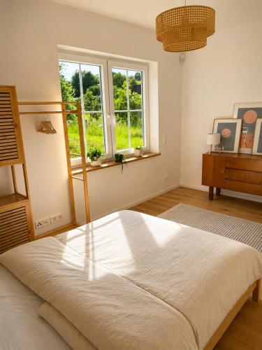 a bedroom with a large bed and a window at Landidylle in Wenden Schönau in Wenden
