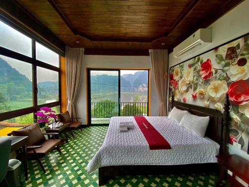 a bedroom with a bed and a large window at Mountain view Homestay in Ninh Binh