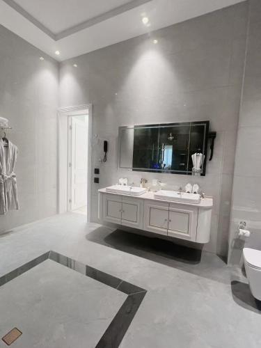 a bathroom with a sink and a large mirror at Ammar Hotel in Dushanbe