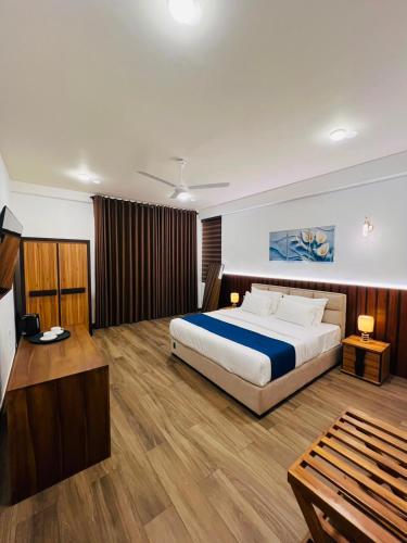 a bedroom with a large bed and a wooden floor at Heda Retreat in Aluthgama