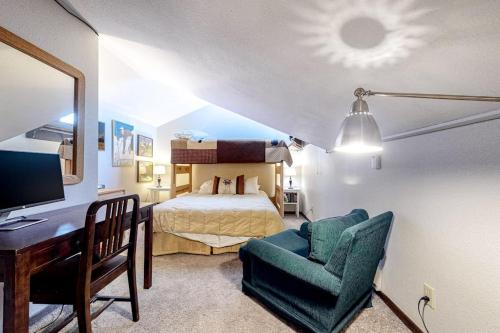 a bedroom with a bed and a desk and a chair at Flying Dutchman 1202 in Keystone