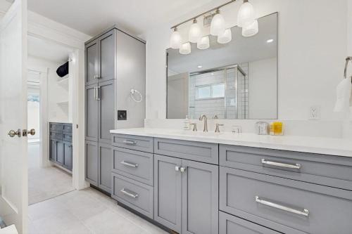 a white bathroom with a sink and a mirror at Library House in Durango