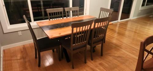 a dining room table with chairs and a wooden table at Pleasant View House in Freeland