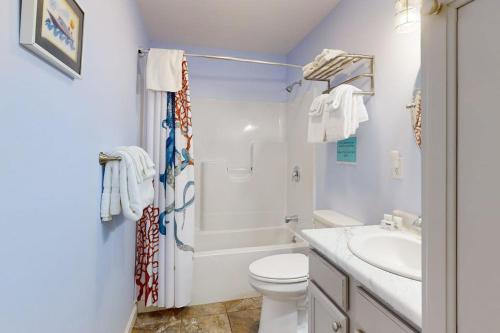 a white bathroom with a toilet and a sink at Post Road Charmer in Moody
