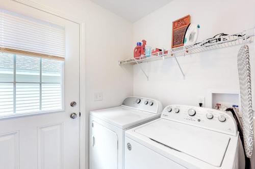 a white laundry room with a washer and dryer at Beacon Retreat in York
