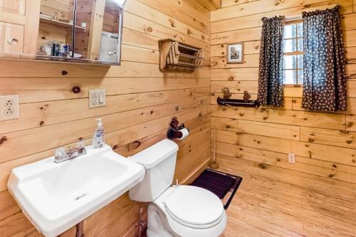 a bathroom with a white sink and a toilet at Lake View Cottage in Leeds