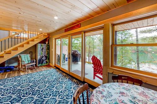 a room with a staircase and a table and chairs at Camp Two Loons in Oxford