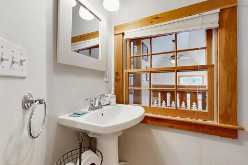 a bathroom with a sink and a window at Mullen Chalet in Greenwood