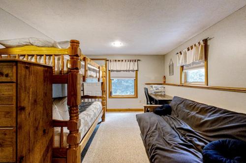 a bedroom with bunk beds and a couch in a room at Sunday River Sunny Chalet in Bethel