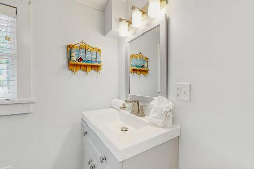 a white bathroom with a sink and a mirror at Long Sands Serenity in York