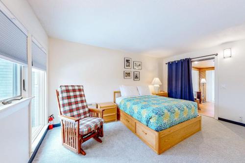 a bedroom with a bed and a chair at Sugarloaf Mountain Treasure in Carrabassett