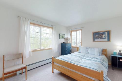 a bedroom with a bed and a chair and a window at Steamboat Springs 1308 in Steamboat Springs
