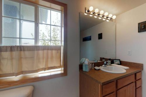 a bathroom with a sink and a mirror and a window at Steamboat Springs 1308 in Steamboat Springs