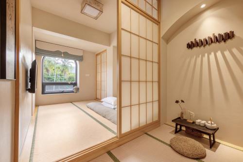 a room with a mirror and a bed in it at Nanxiang Shushan Hotel in Sanya