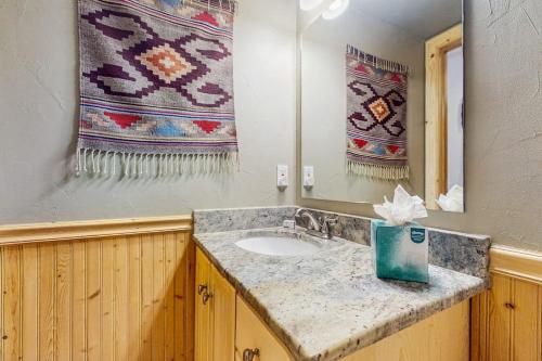 a bathroom with a sink and a mirror and towels at Harris House in Breckenridge