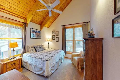 a bedroom with a bed and a ceiling fan at Kick Back Cabin in Pagosa Springs