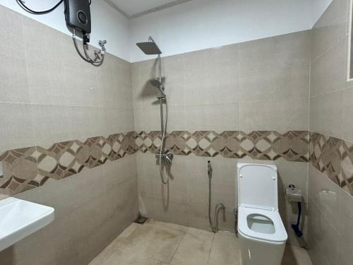 a bathroom with a shower and a toilet and a sink at Eco Camping Resort Ella in Bandarawela