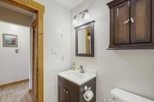 a bathroom with a sink and a toilet and a mirror at Ore House 8 in Frisco