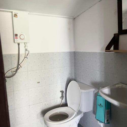 a bathroom with a toilet and a sink at Benny Seaview house in Ao Phutsa
