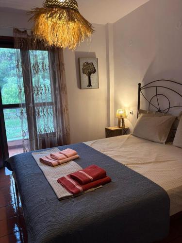 a bedroom with a bed with two towels on it at Aithra House Αίθρα in Toroni
