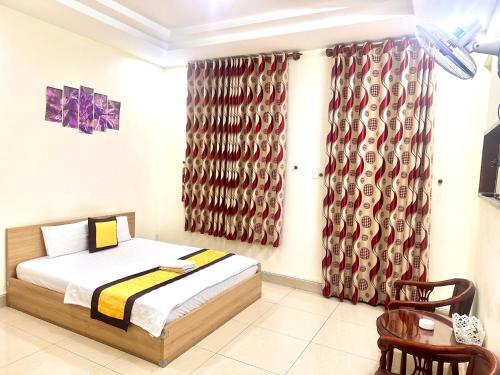 a bedroom with a bed and a window with curtains at 158A Hotel in Ho Chi Minh City