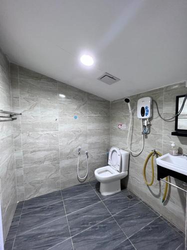 a bathroom with a shower and a toilet and a sink at Asni chalet in Marang