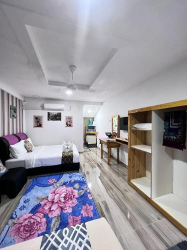 a large room with a bed and a rug at Asni chalet in Marang