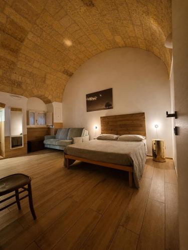 a large bedroom with a bed and a couch at B&B Novecento Italiano in Altamura
