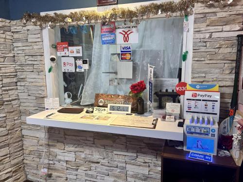 a counter in a store with a stone wall at Nikko Park Lodge Mountain Side in Nikko