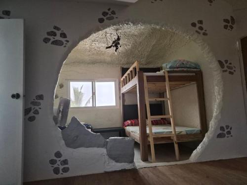 a room with a hole in the wall at Beachfront AC Cave Cabin for 10pax in Caba