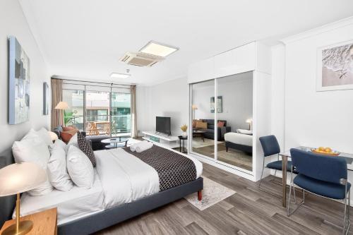 a bedroom with a bed and a living room at 188 Apartments in Perth