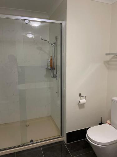 a bathroom with a shower and a toilet at Salt and Sea-renity in Russell Island