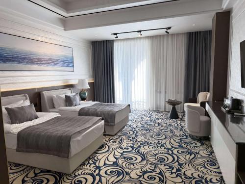 a hotel room with two beds and a room with at Mustafa Hotel in Samarkand